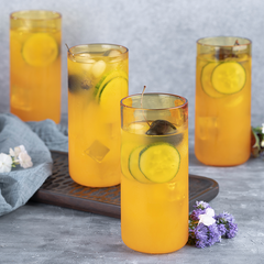 Juliette Cocktail Glasses, set of  4 borosilicate glasses in yellow color, filled with juice.