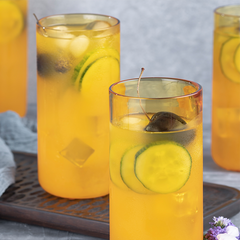 Close view of Juliette Cocktail Glasses, borosilicate glasses in yellow color, filled with juice.